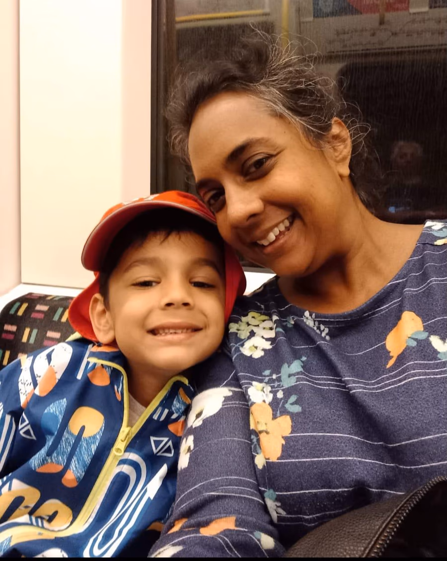 Joanne smiling with a child.