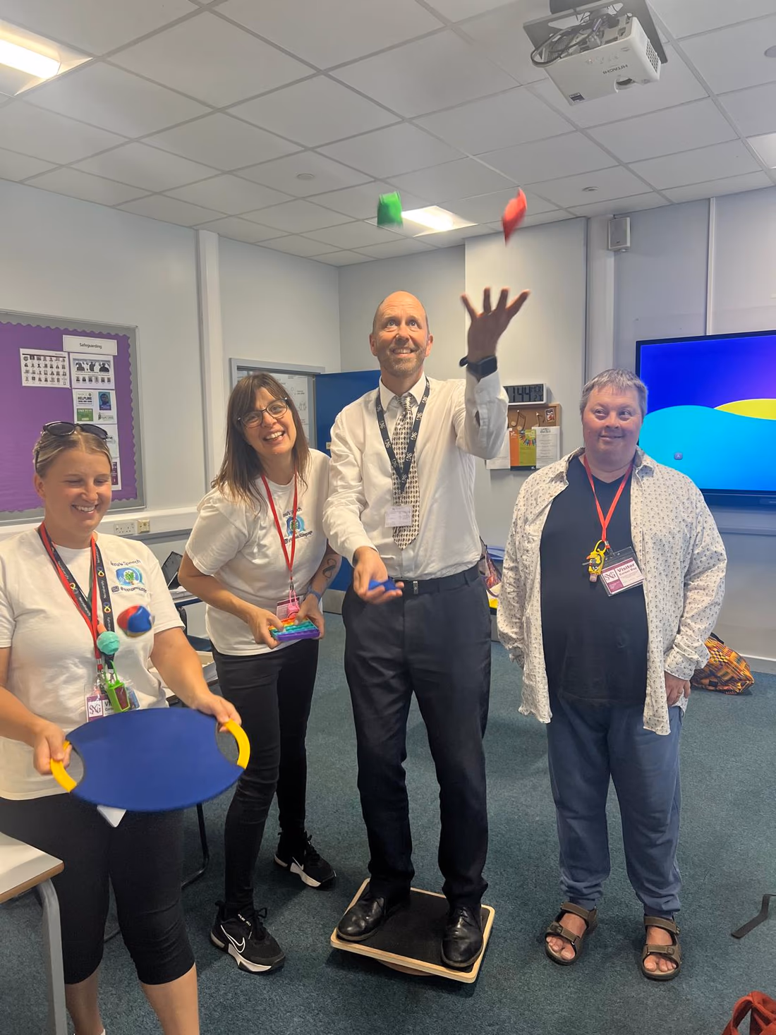 Anna and school staff taking part in a practical communication training activity.